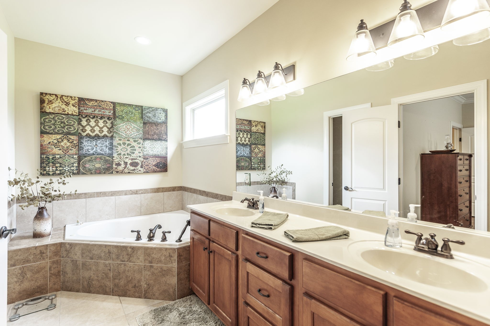 1017 Kendras Run Gallatin, TN 37066 - Photo 26 of 54 a bathroom with a tub a double vanity sink and mirror