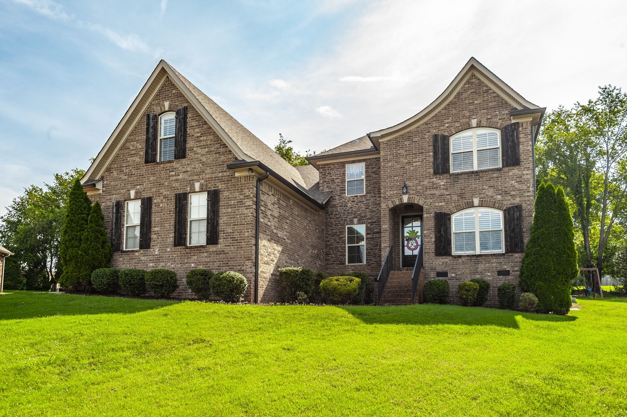 1017 Kendras Run Gallatin, TN 37066 - Photo 5 of 54 a front view of a house with a yard and garage