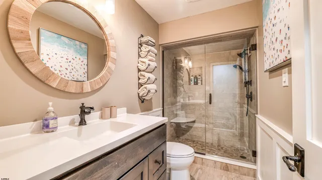 a bathroom with a sink a toilet and shower