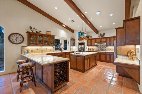 a kitchen with stainless steel appliances granite countertop a sink and a refrigerator