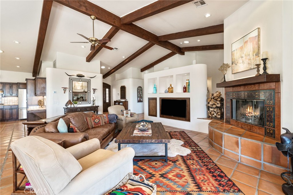 60150 Santa Rosa Road Mountain Center, CA 92561 - Photo 13 of 49 a living room with furniture a fireplace and a flat screen tv