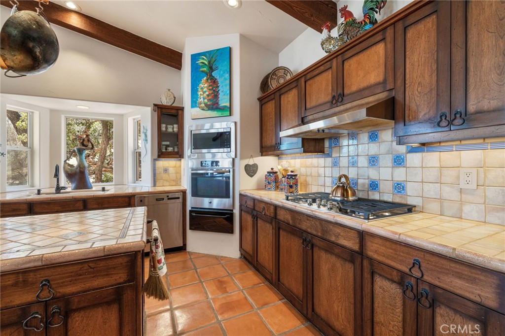 60150 Santa Rosa Road Mountain Center, CA 92561 - Photo 15 of 49 a kitchen with stainless steel appliances granite countertop a stove a sink and a refrigerator