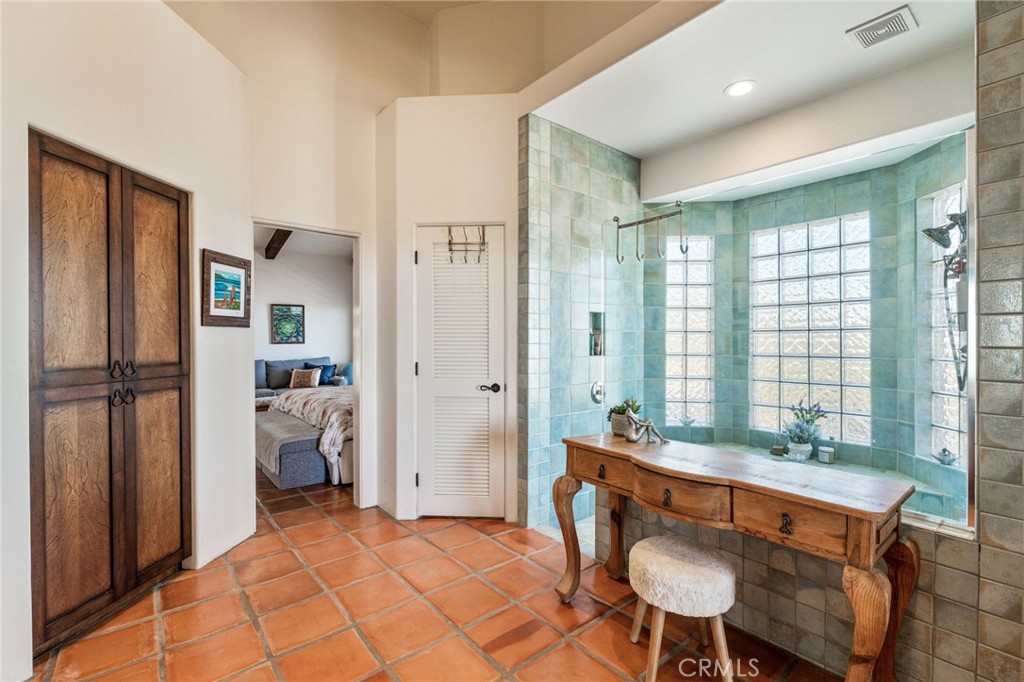 60150 Santa Rosa Road Mountain Center, CA 92561 - Photo 22 of 49 a spacious bathroom with a granite countertop sink and a mirror