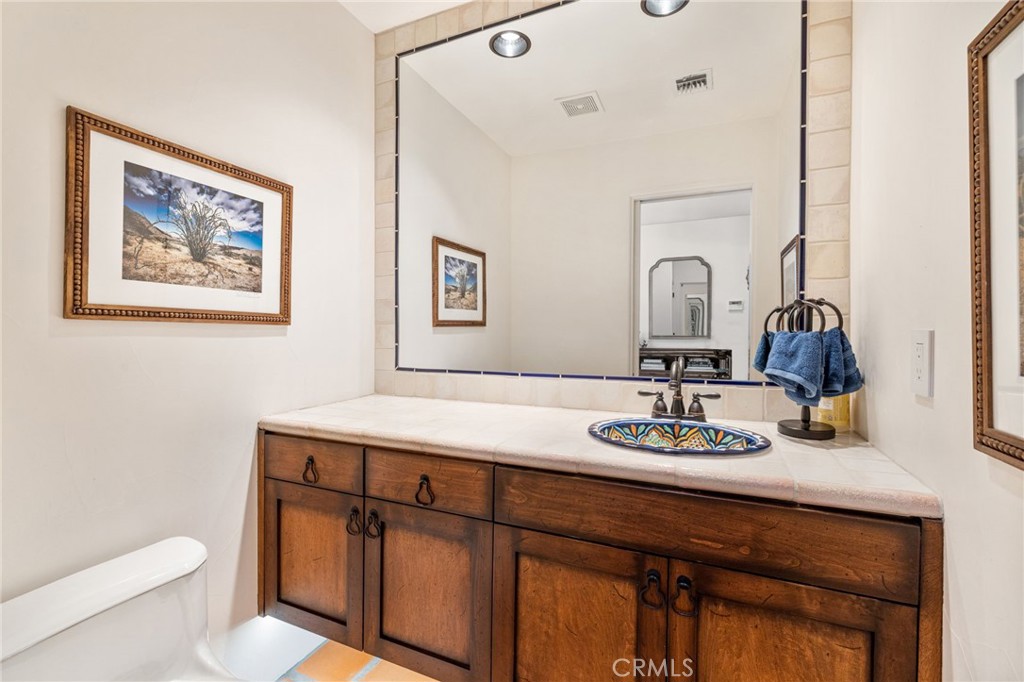 60150 Santa Rosa Road Mountain Center, CA 92561 - Photo 30 of 49 a bathroom with a sink a toilet and a mirror