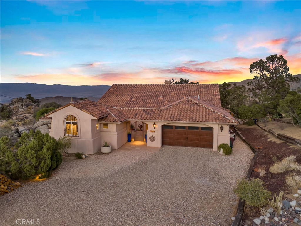 60150 Santa Rosa Road Mountain Center, CA 92561 - Photo 3 of 49 a view of a big house with a big yard and large trees