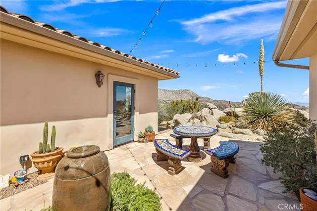 a view of a chairs and table in patio