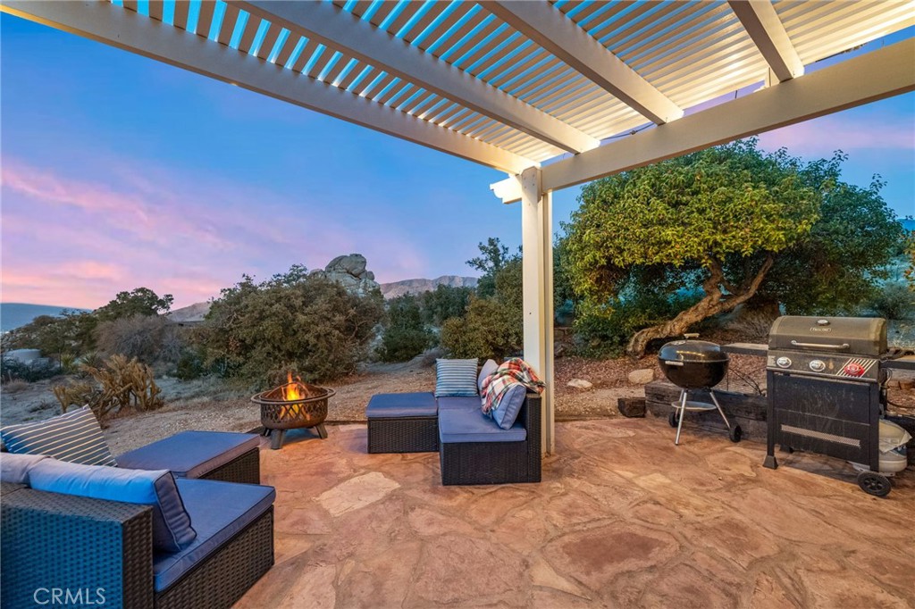 60150 Santa Rosa Road Mountain Center, CA 92561 - Photo 46 of 49 a view of a patio with couches table and chairs and potted plants