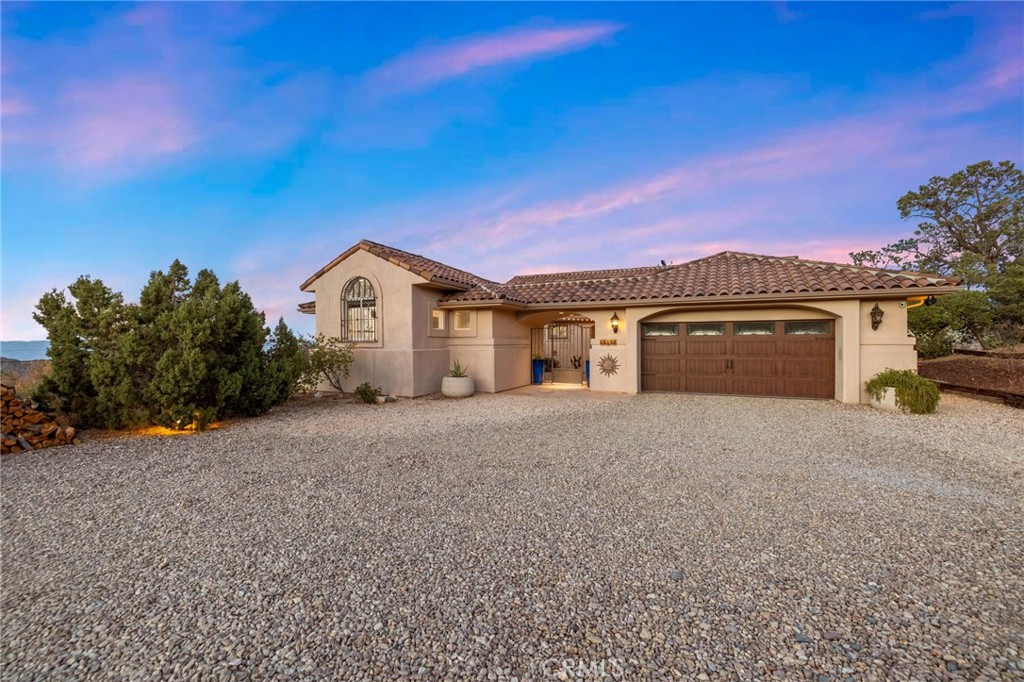 60150 Santa Rosa Road Mountain Center, CA 92561 - Photo 48 of 49 a front view of a house with a yard and garage