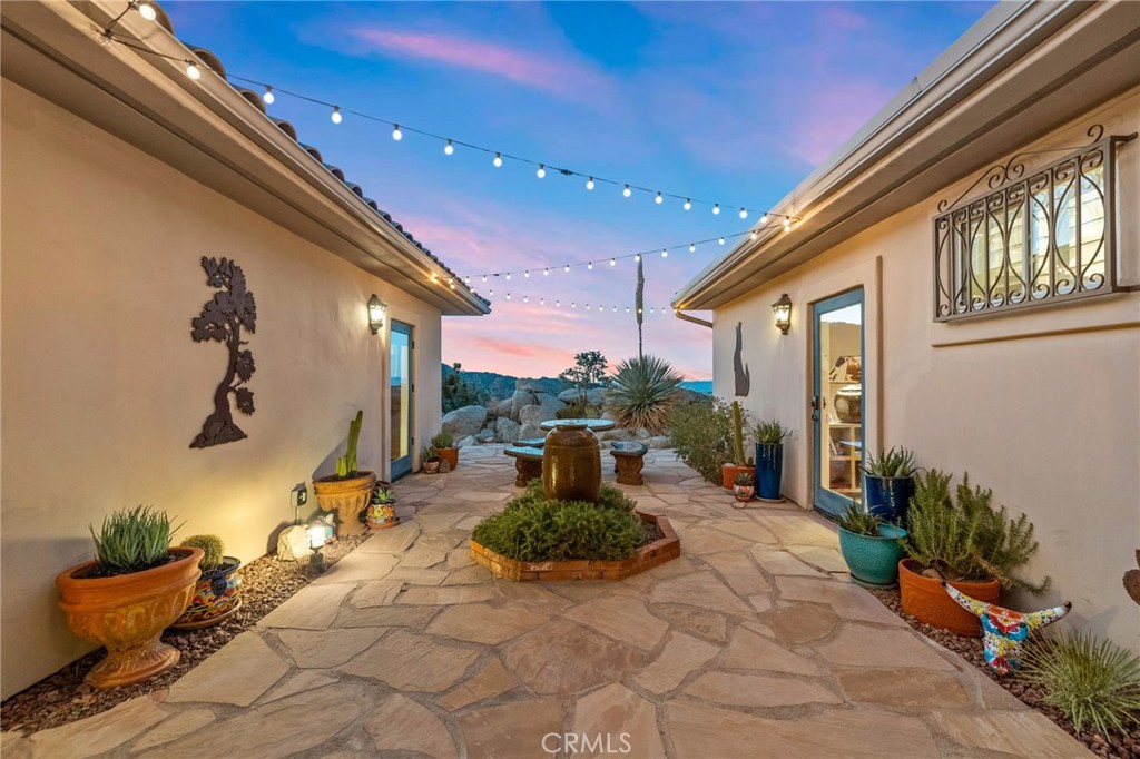 60150 Santa Rosa Road Mountain Center, CA 92561 - Photo 7 of 49 a view of a patio with couches chairs potted plants and floor to ceiling window