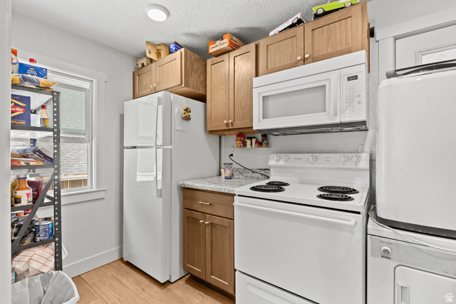 661 East 600 North Logan, UT 84321 - Photo 11 of 15 Kitchen featuring wood-finish flooring, light wood cabinetry, white appliances, and a window for natural illumination