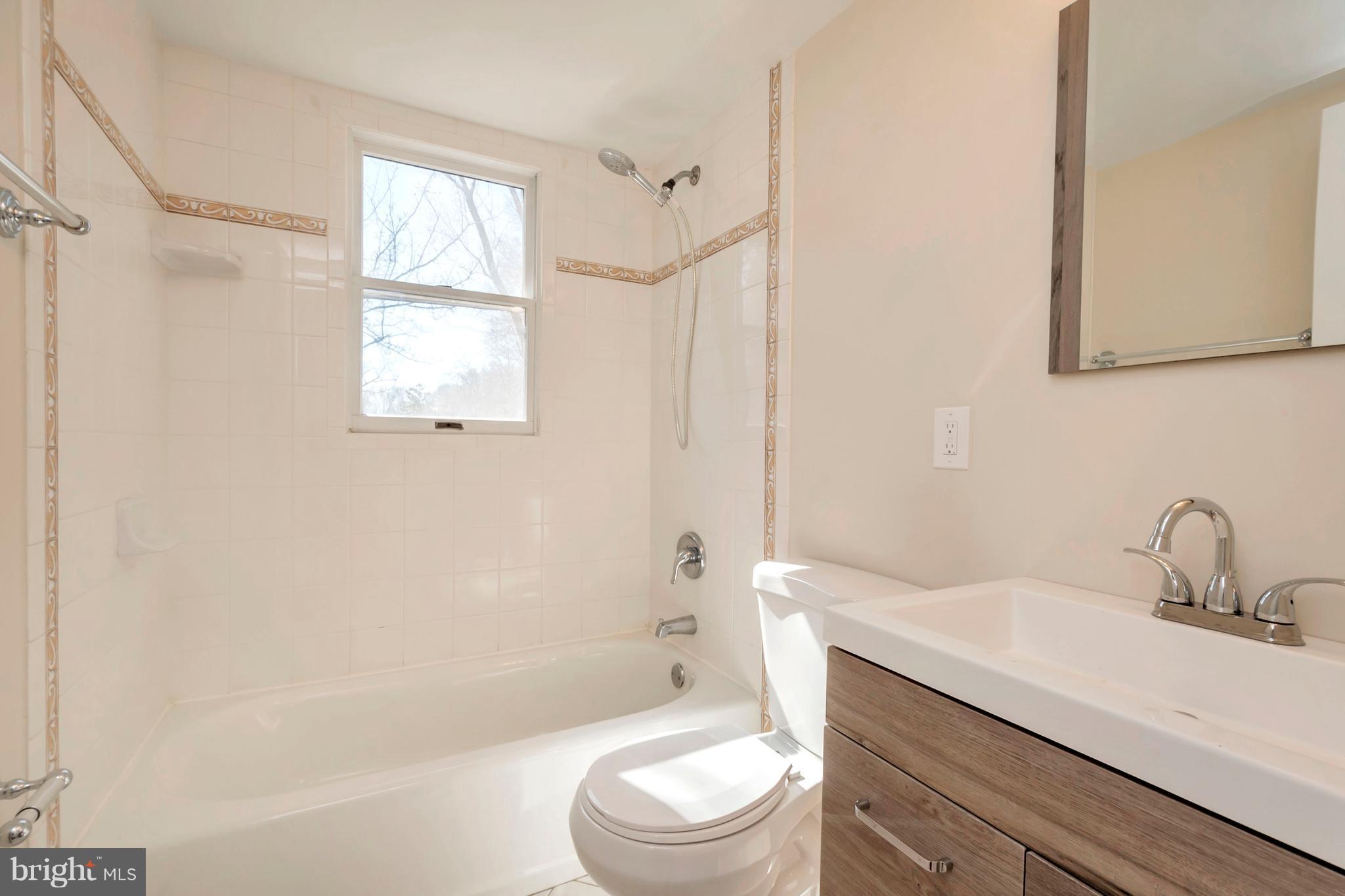 14114 Grayson Road Woodbridge, VA 22191 - Photo 11 of 28 a bathroom with a sink a toilet and shower