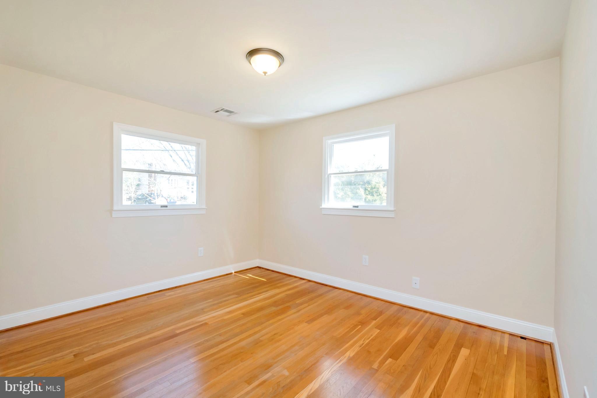 14114 Grayson Road Woodbridge, VA 22191 - Photo 13 of 28 an empty room with wooden floor and windows