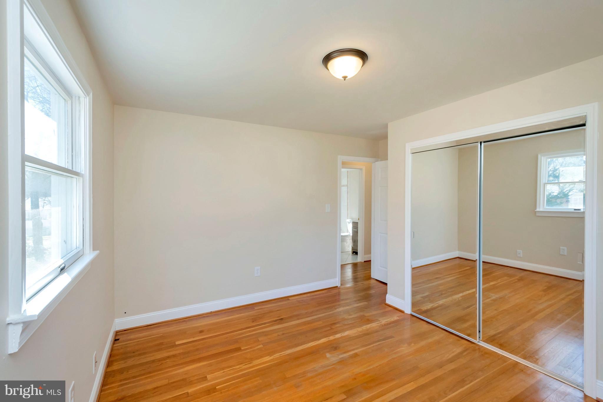 14114 Grayson Road Woodbridge, VA 22191 - Photo 14 of 28 a view of an empty room with window and wooden floor