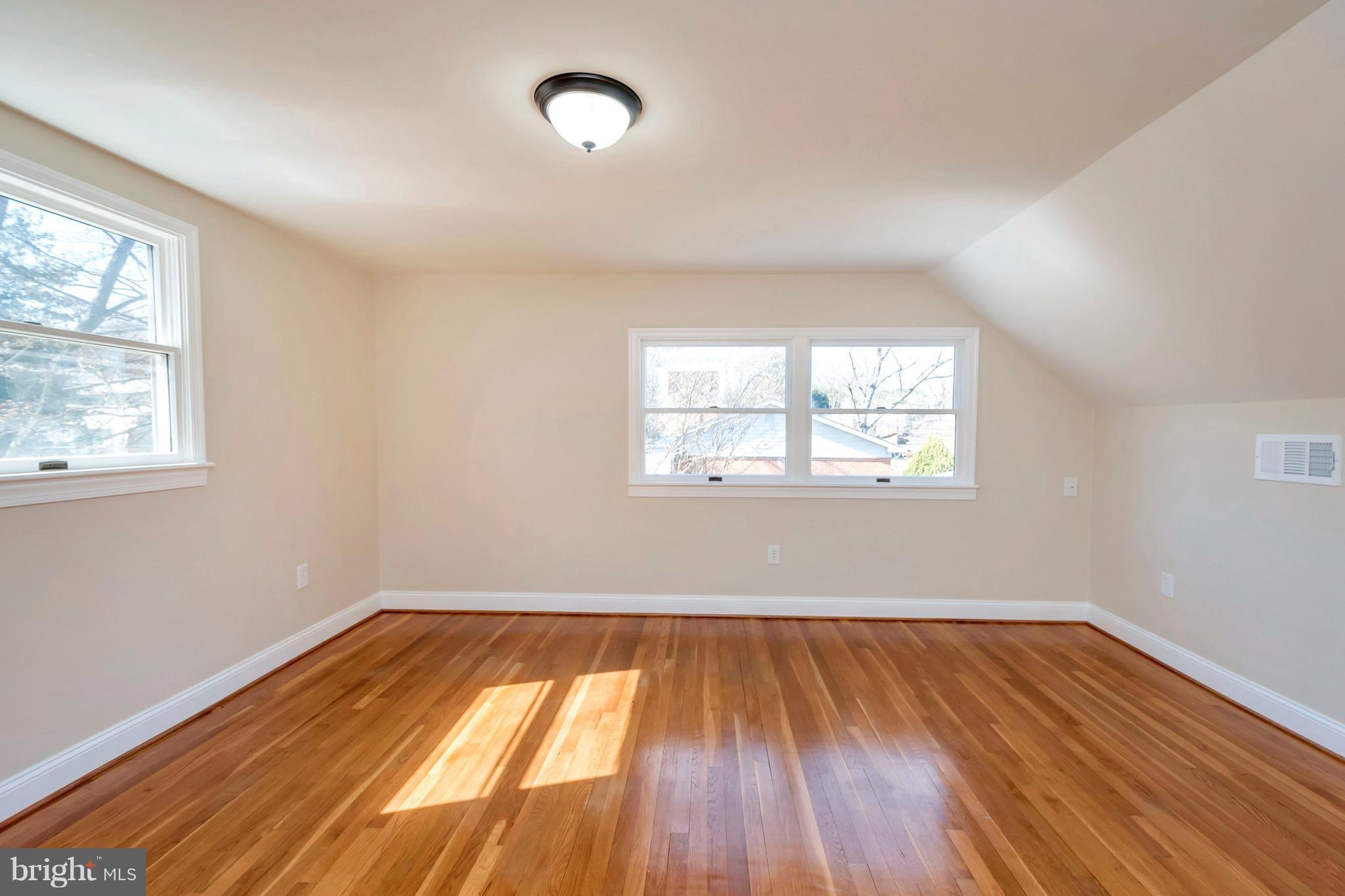 14114 Grayson Road Woodbridge, VA 22191 - Photo 22 of 28 an empty room with wooden floor and windows