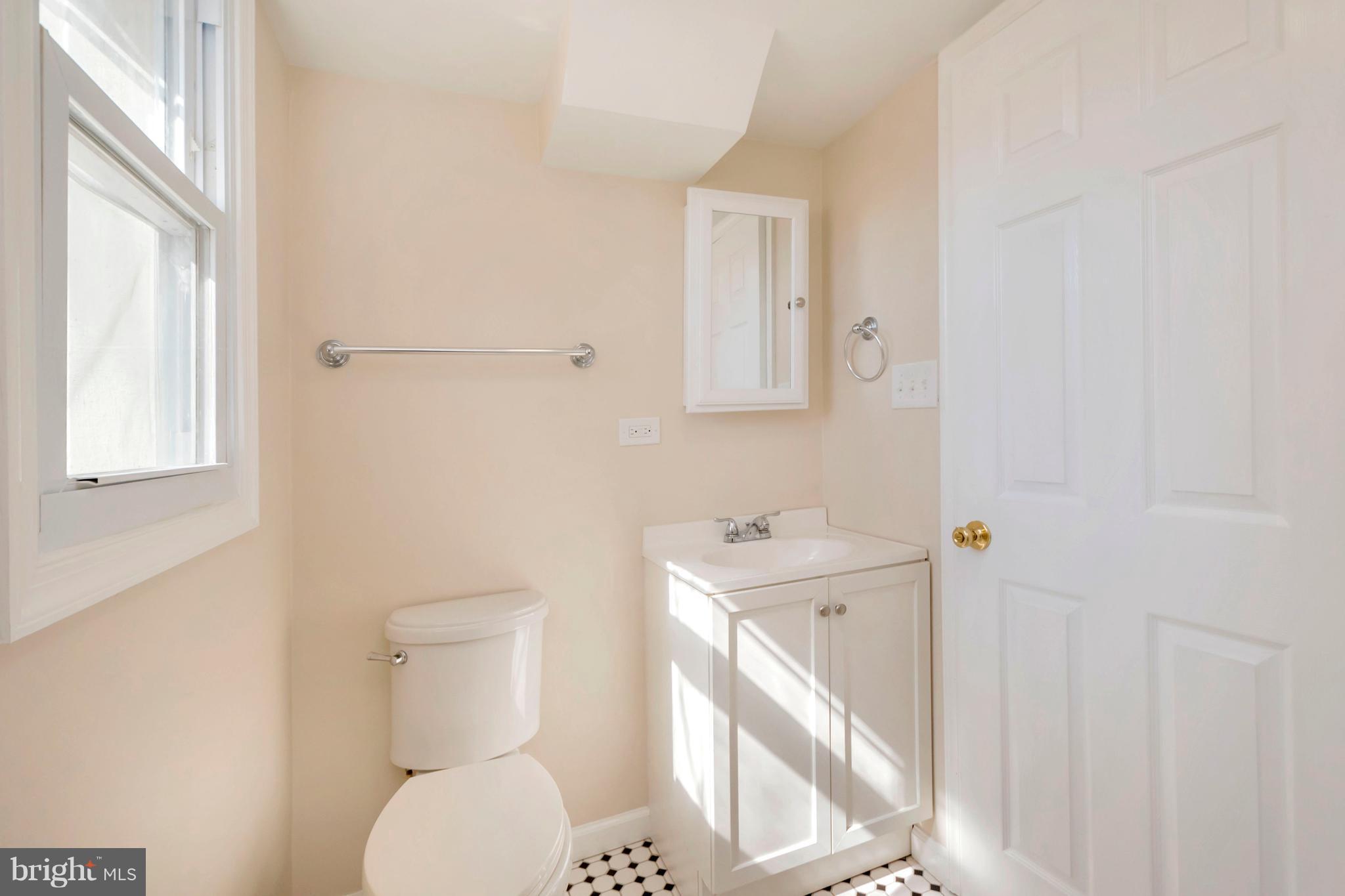 14114 Grayson Road Woodbridge, VA 22191 - Photo 27 of 28 a bathroom with a toilet a sink and mirror