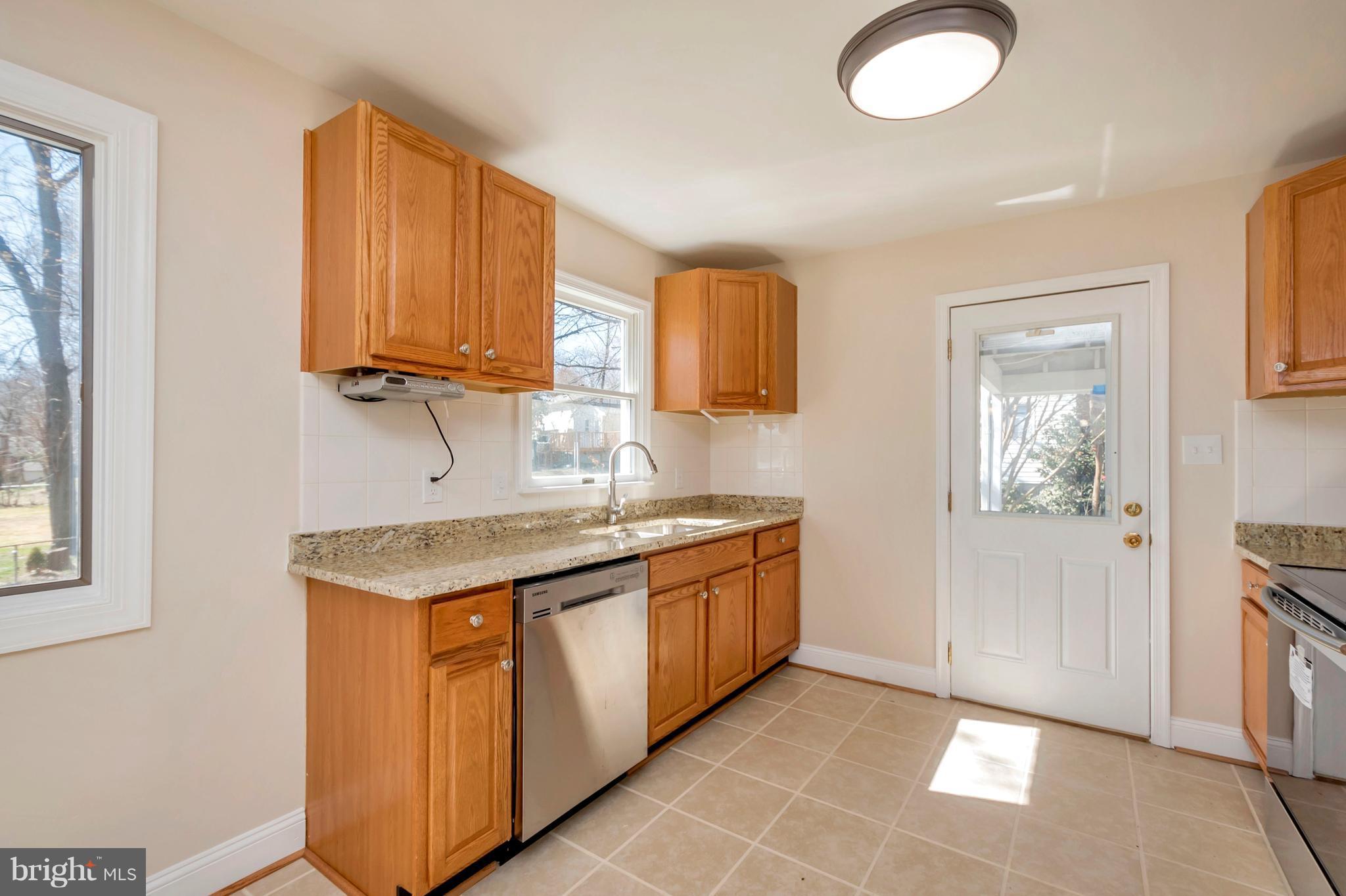 14114 Grayson Road Woodbridge, VA 22191 - Photo 8 of 28 a kitchen with granite countertop a sink and a stove