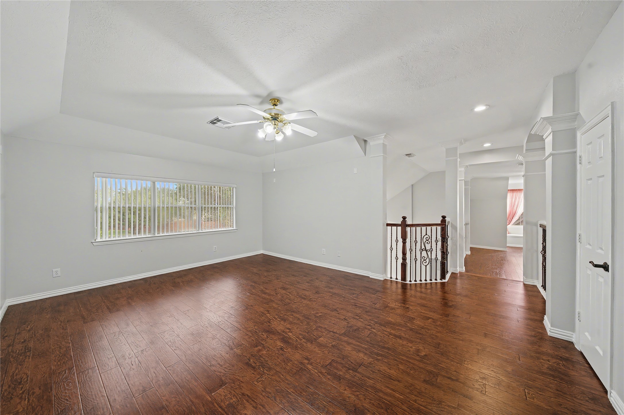 5403 Emerald Pointe Lane Sugar Land, TX 77479 - Photo 45 of 50 a view of an empty room with wooden floor and a ceiling fan