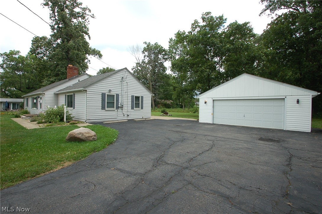 1299 State Road Vermilion, OH 44089 - Photo 32 of 36 View of side of property with a garage, a yard, and an 2 car garage