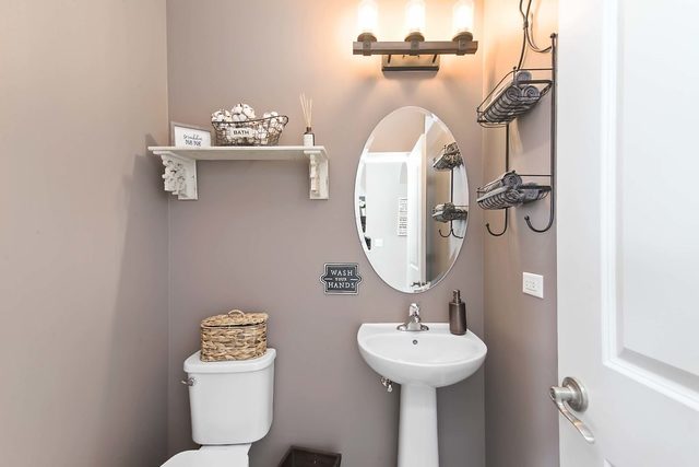 2050 Stapleton Road New Lenox, IL 60451 - Photo 16 of 38 a bathroom with a sink a toilet and mirror