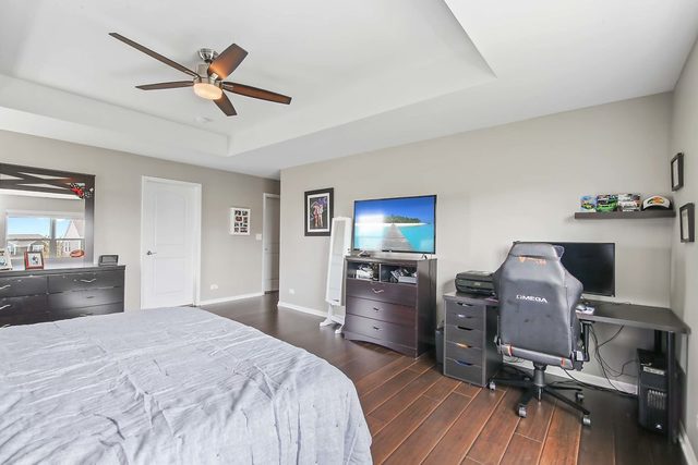 2050 Stapleton Road New Lenox, IL 60451 - Photo 22 of 38 a bedroom with a bed and a chandelier