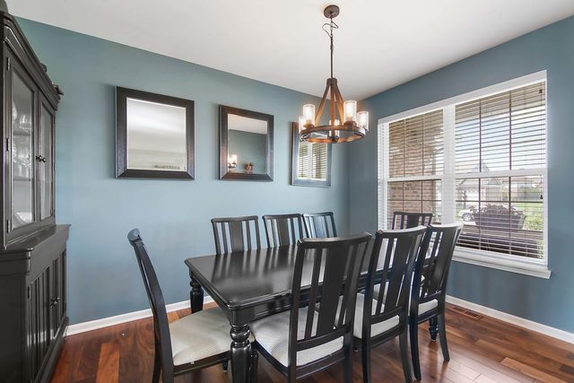 2050 Stapleton Road New Lenox, IL 60451 - Photo 4 of 38 a view of a dining room with furniture wooden floor and chandelier