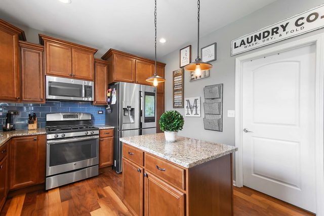2050 Stapleton Road New Lenox, IL 60451 - Photo 8 of 38 a kitchen with stainless steel appliances granite countertop a stove and a refrigerator