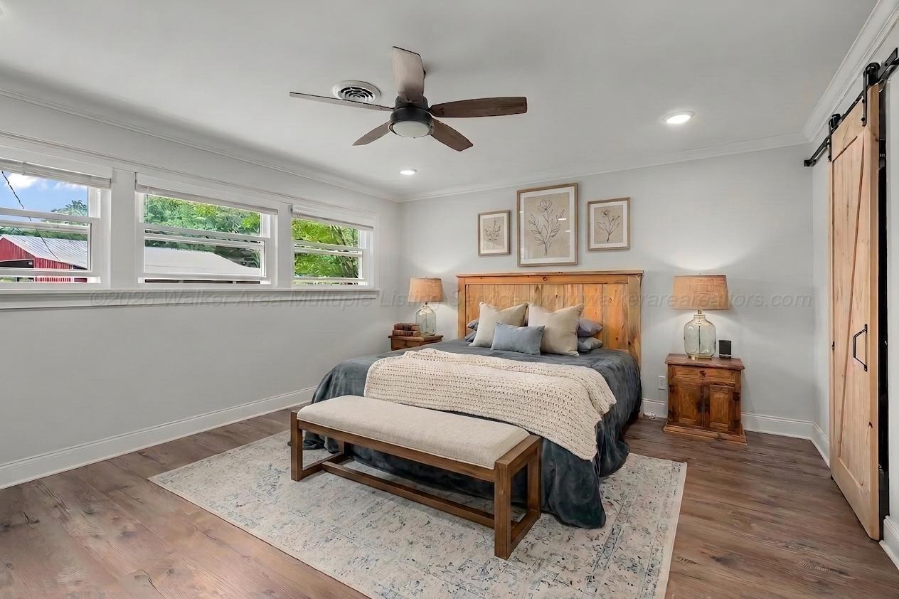 1751 North Walston Bridge Road Jasper, AL 35504 - Photo 27 of 52 Primary bedroom virtually staged with furniture. Barn door slider to walk-in closet.