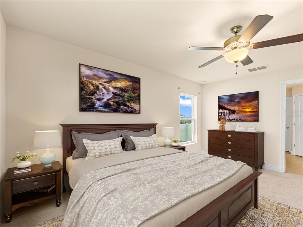 2412 Twin Lake View Road Winter Haven, FL 33881 - Photo 11 of 26 a bedroom with a bed and a chandelier