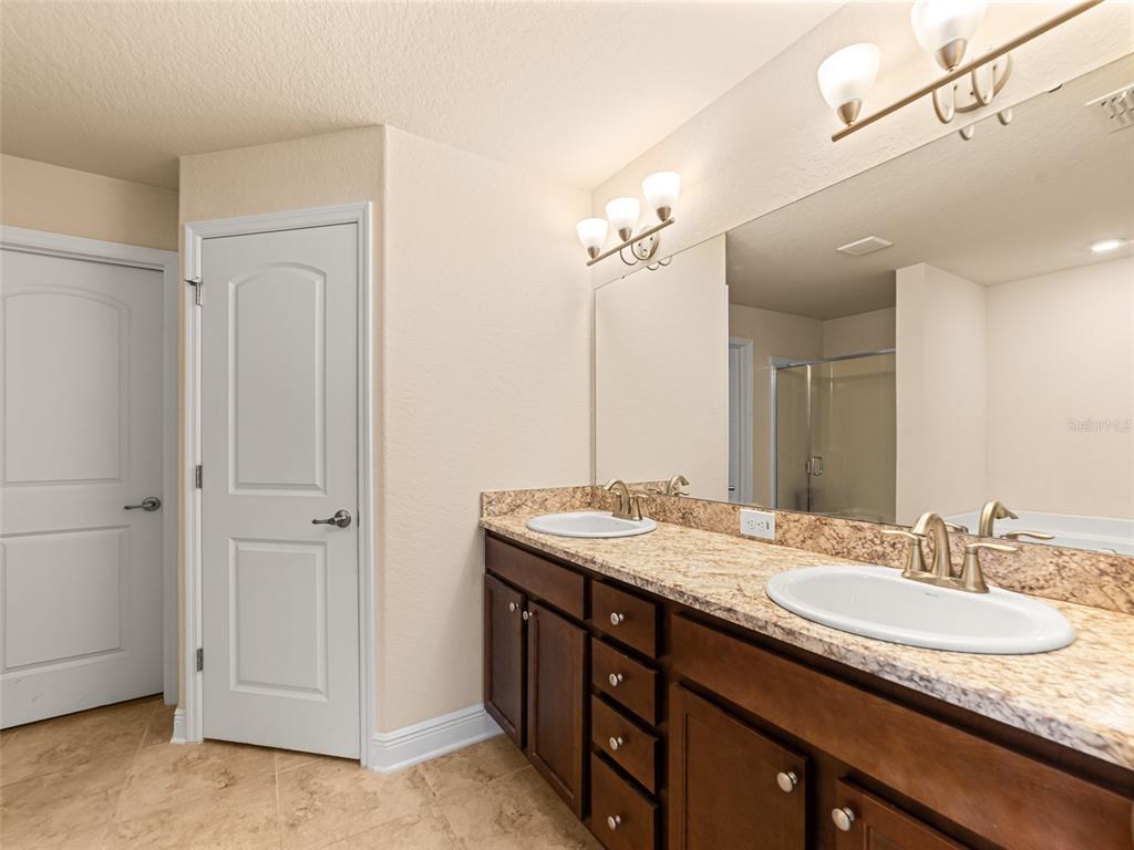 2412 Twin Lake View Road Winter Haven, FL 33881 - Photo 13 of 26 a bathroom with a granite countertop sink and a mirror