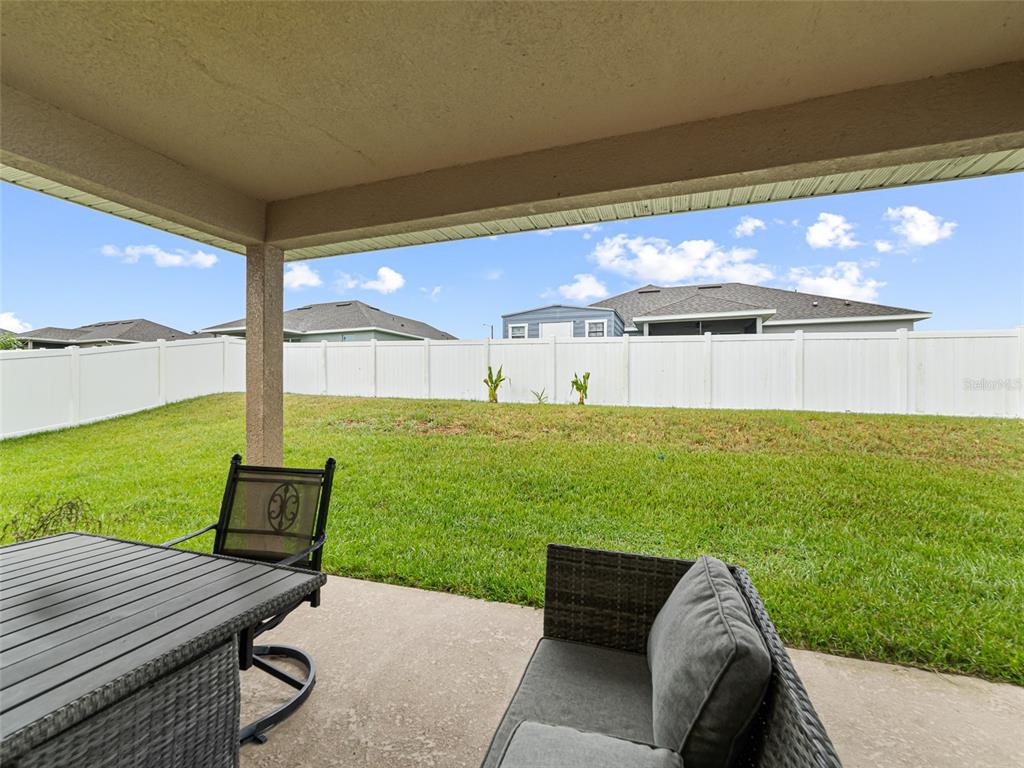 2412 Twin Lake View Road Winter Haven, FL 33881 - Photo 20 of 26 a view of a two chairs and table in the patio