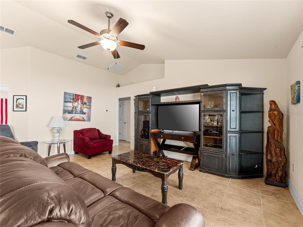 2412 Twin Lake View Road Winter Haven, FL 33881 - Photo 5 of 26 a living room with furniture a ceiling fan and a rug