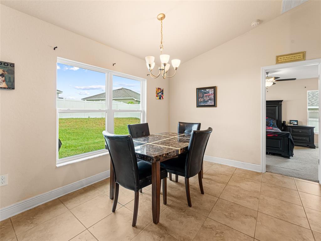 2412 Twin Lake View Road Winter Haven, FL 33881 - Photo 7 of 26 a view of a dining room with furniture window and outside view
