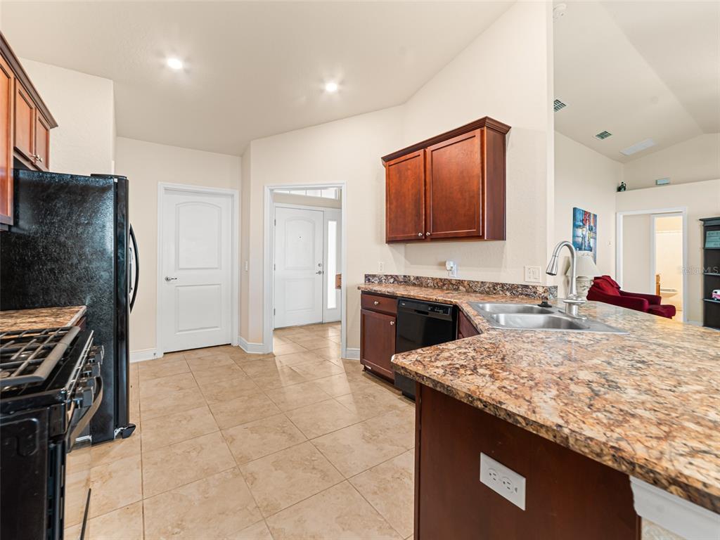 2412 Twin Lake View Road Winter Haven, FL 33881 - Photo 9 of 26 a kitchen with a stove and a refrigerator