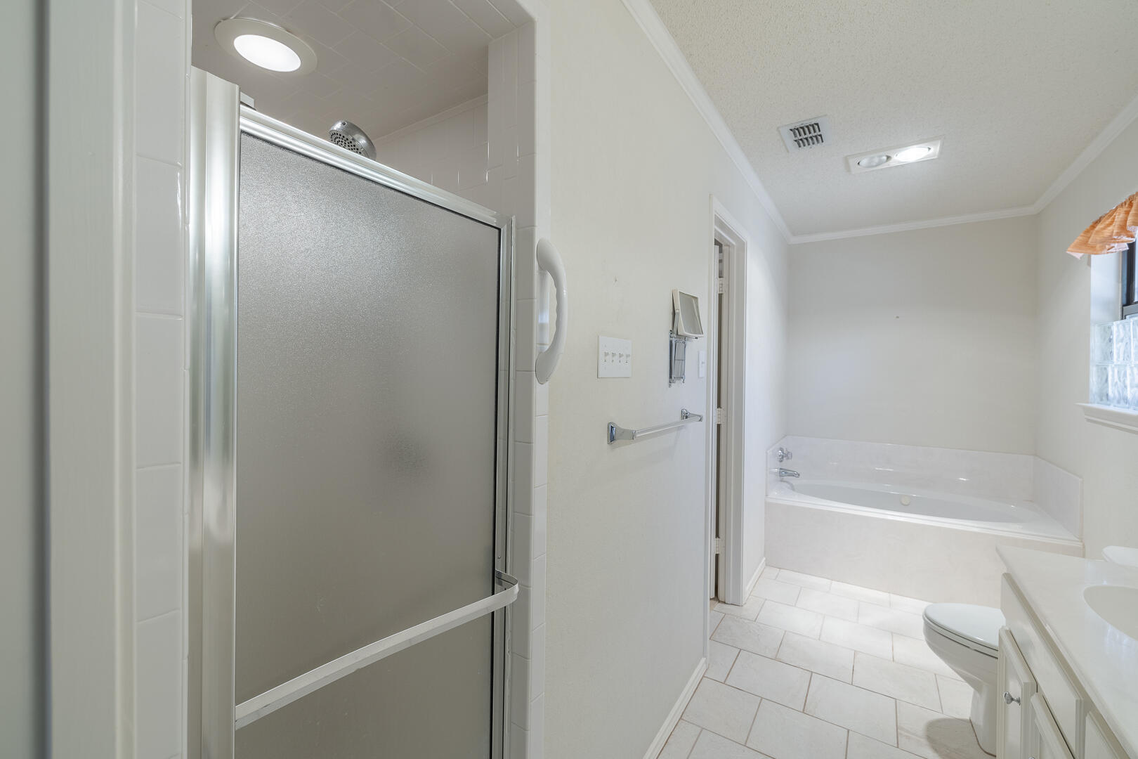 5415 68th Street Lubbock, TX 79424 - Photo 16 of 57 a bathroom with a bathtub and a shower