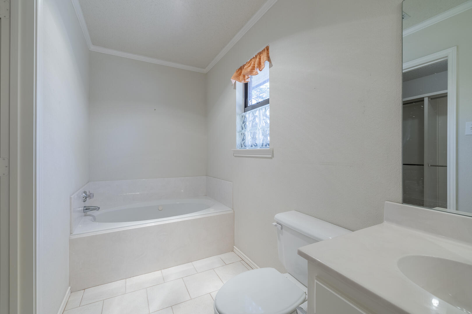 5415 68th Street Lubbock, TX 79424 - Photo 18 of 57 a white bath tub sitting next to a white toilet