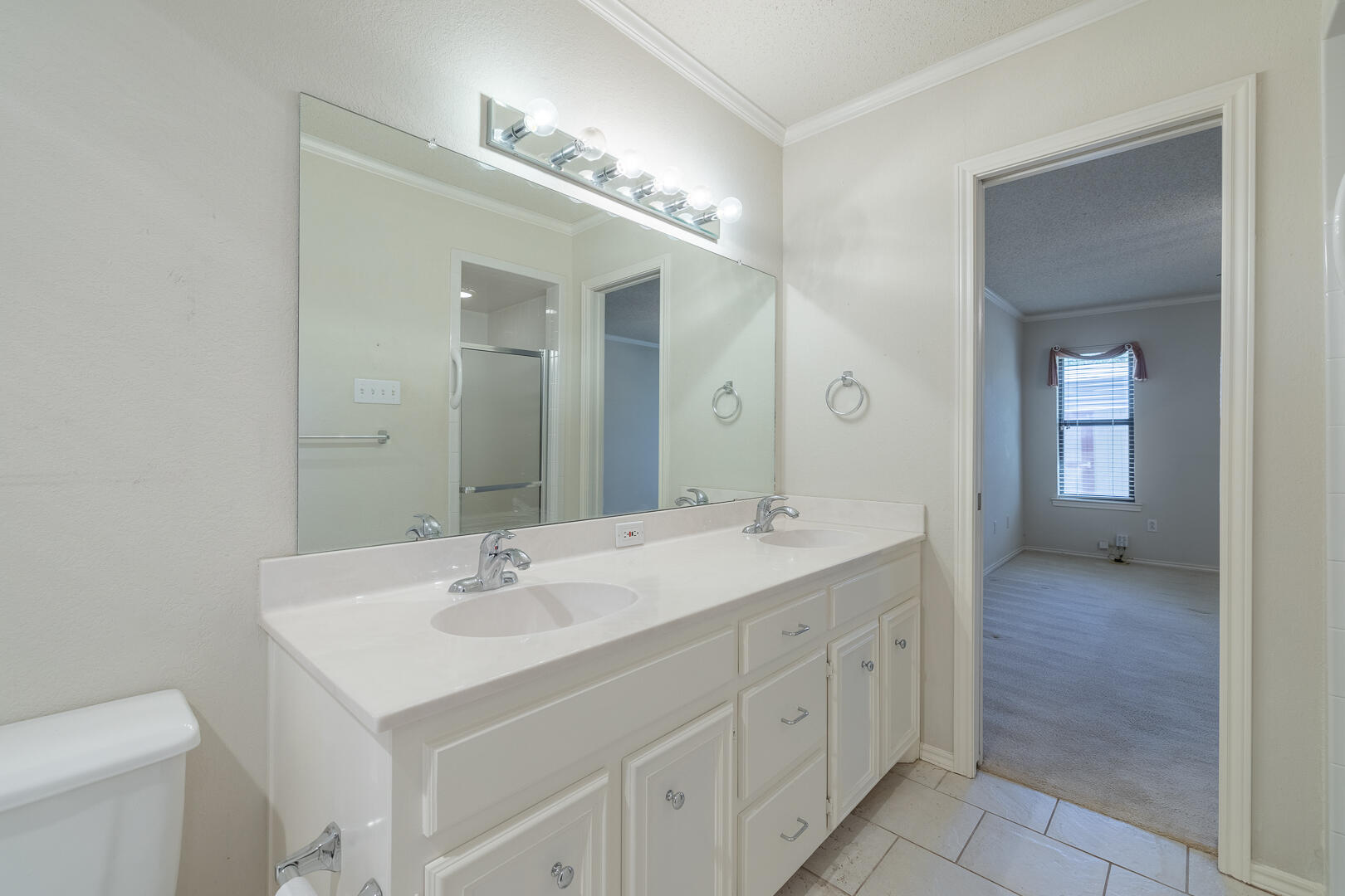 5415 68th Street Lubbock, TX 79424 - Photo 19 of 57 a bathroom with a sink and a mirror