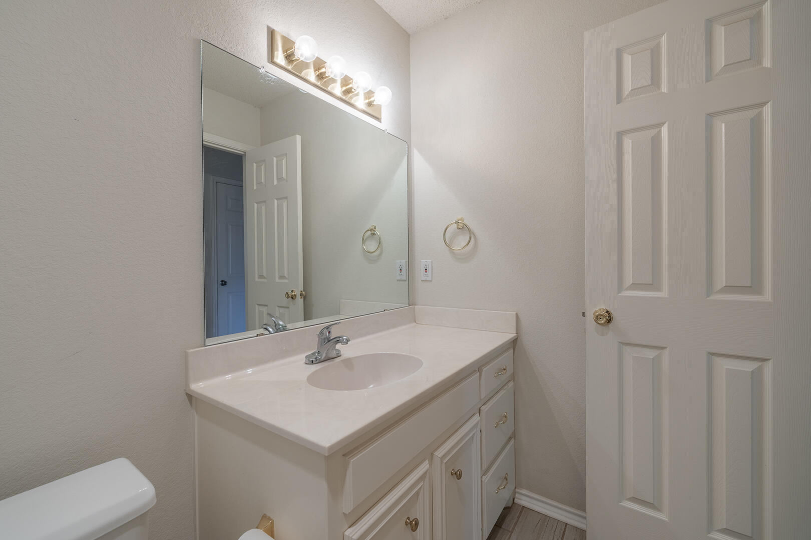 5415 68th Street Lubbock, TX 79424 - Photo 28 of 57 a bathroom with a sink and a mirror