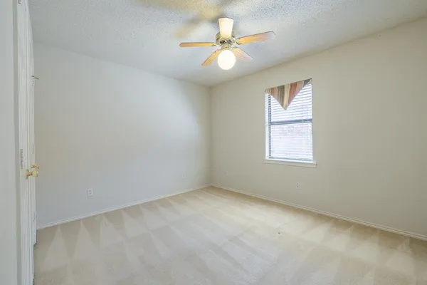 a kitchen with cabinets and window