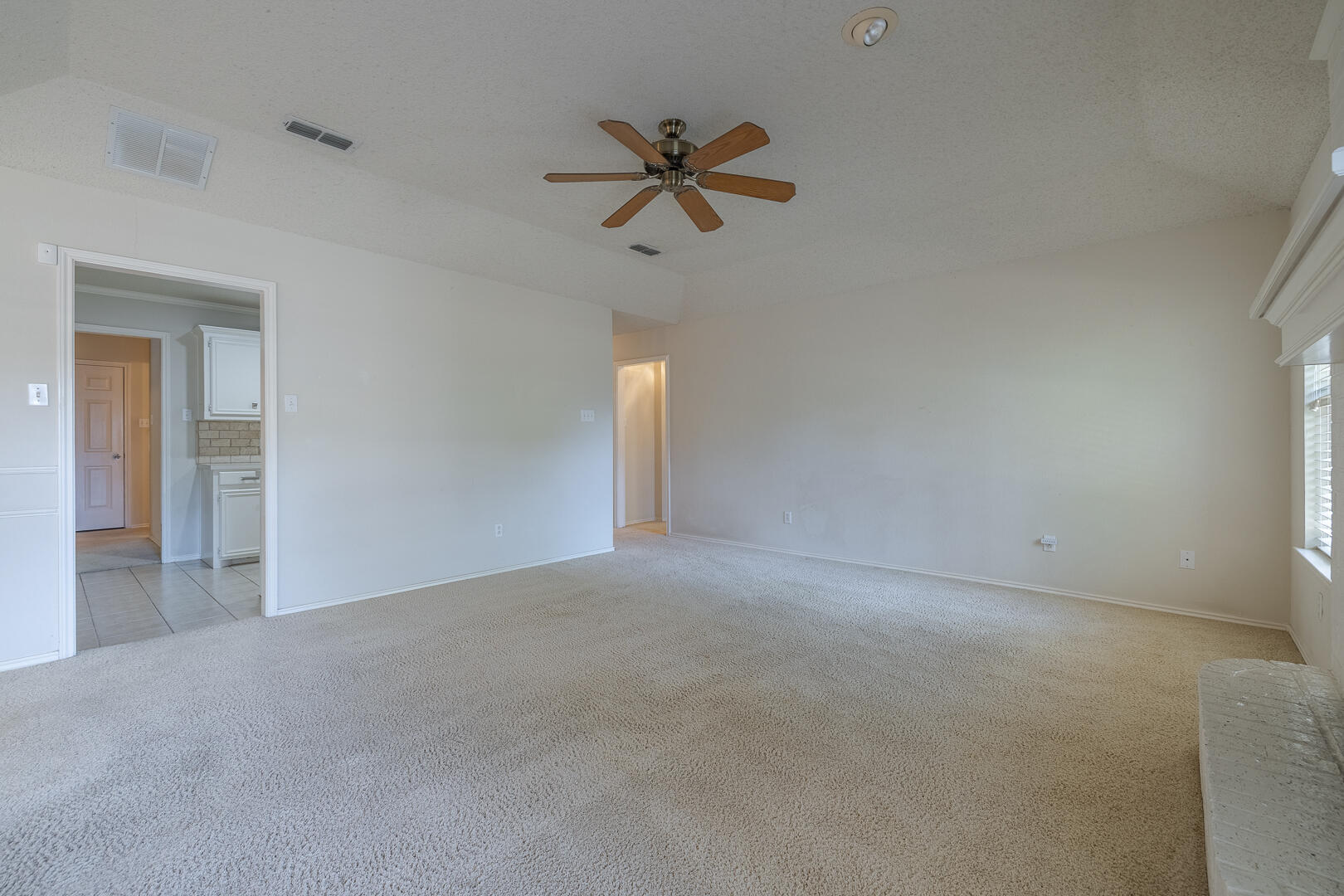 5415 68th Street Lubbock, TX 79424 - Photo 42 of 57 a view of a livingroom with a ceiling fan and window