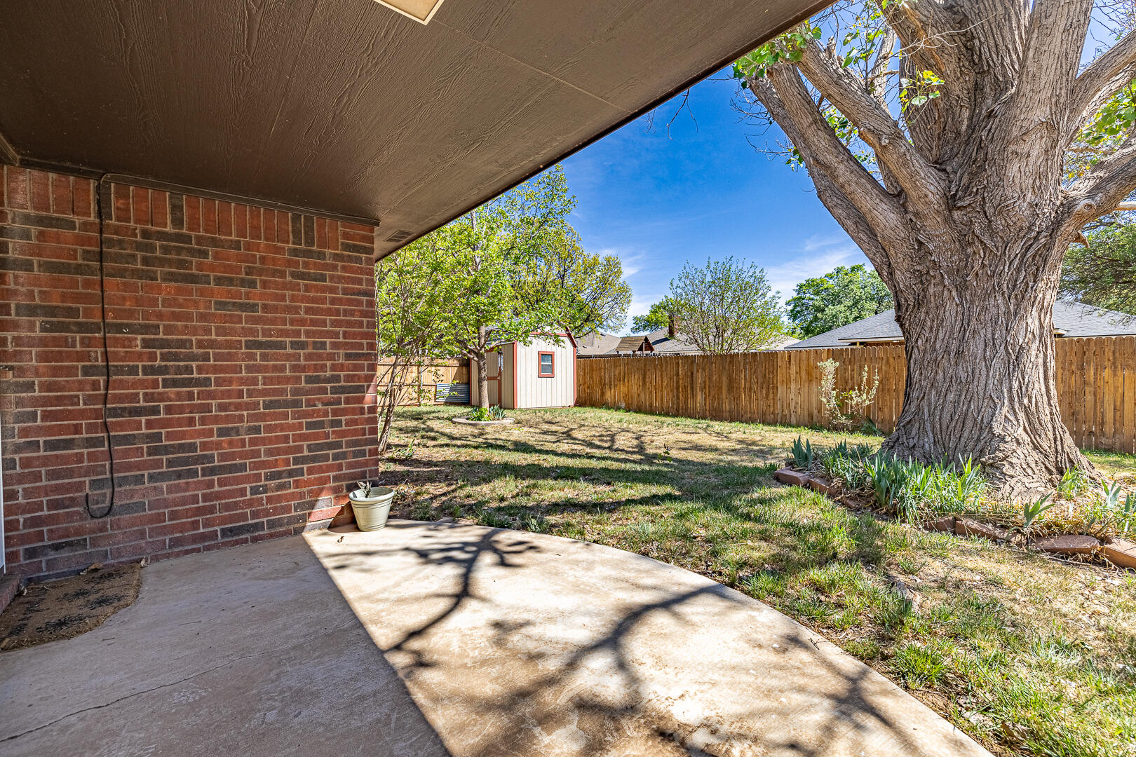 5415 68th Street Lubbock, TX 79424 - Photo 52 of 57 a view of a backyard with a tree
