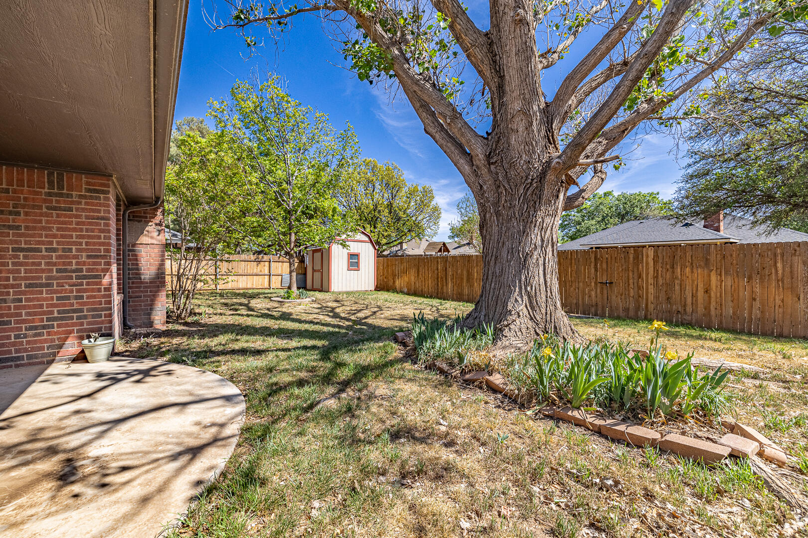 5415 68th Street Lubbock, TX 79424 - Photo 53 of 57 a backyard of a house with lots of green space