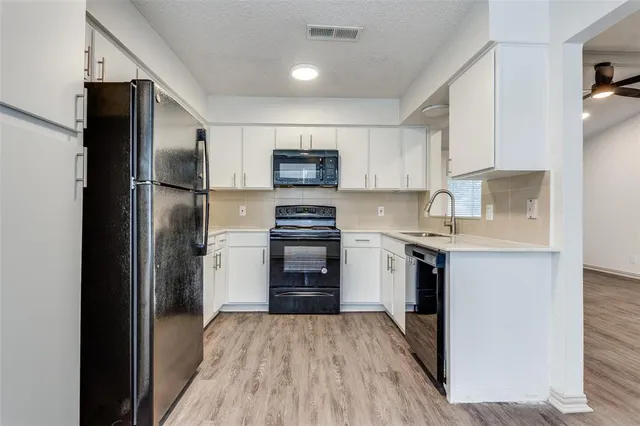 a kitchen with a refrigerator stove and sink
