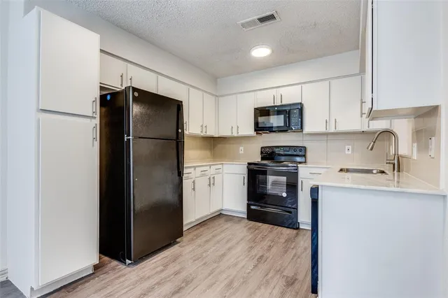 a kitchen with a refrigerator stove and sink