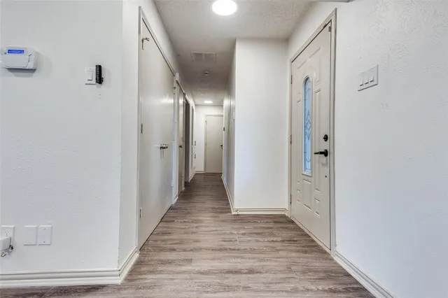 a view of a hallway with wooden floor