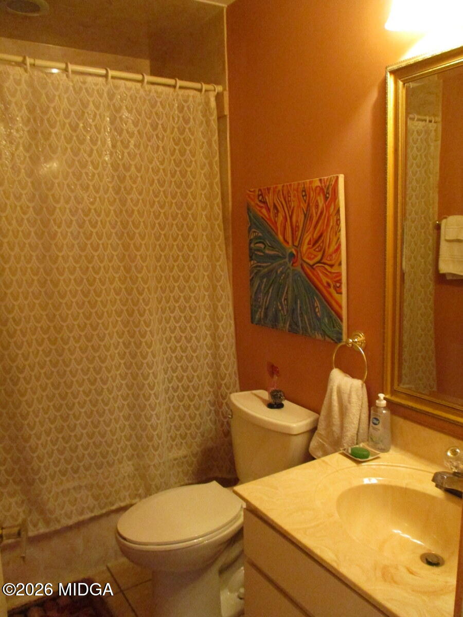 1121 South Jackson Springs Road Macon, GA 31211 - Photo 26 of 29 a white toilet sitting next to a bathroom sink