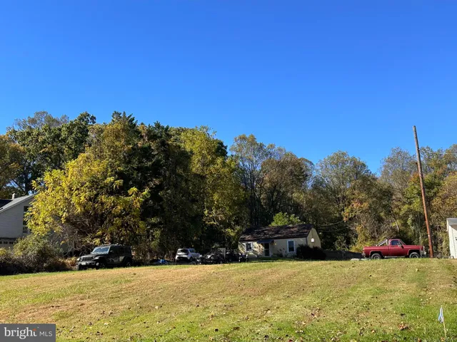a view of a field with trees in the background