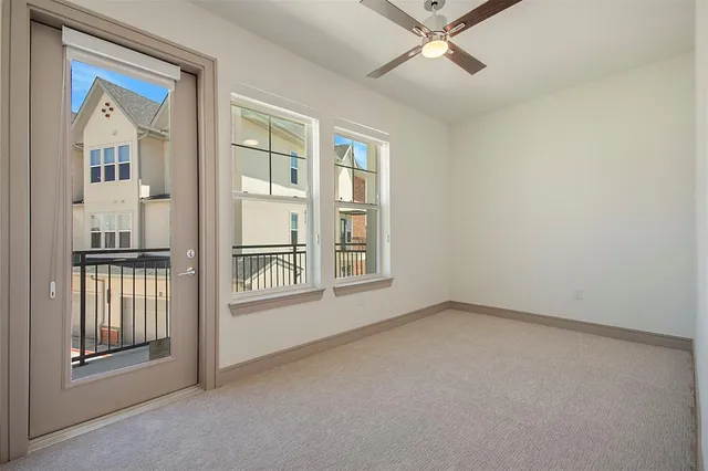 an empty room with windows and entryway
