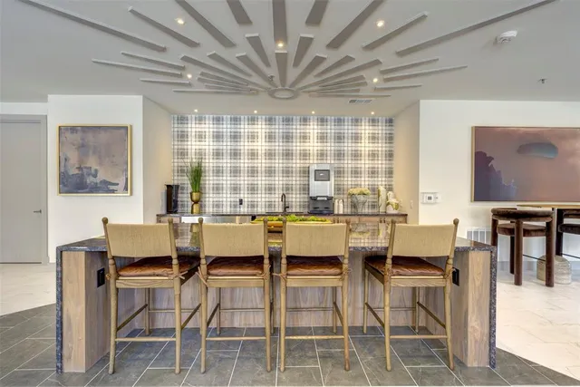 a dining room with furniture a chandelier and wooden floor