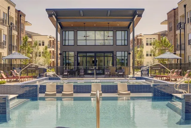 a view of a swimming pool with outdoor seating