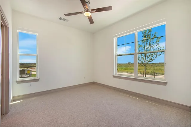 a view of an empty room with a window